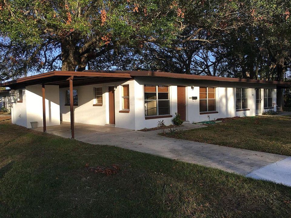 309 is the unit of this duplex on the left. It has its own covered driveway and laundry/utility room as shown in the photo on the far left.