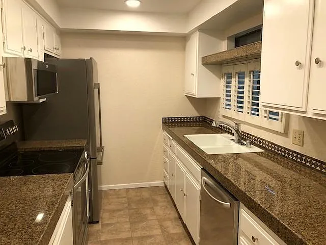 Granite Counters in Kitchen with Stainless Steel Appliances.