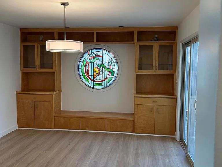 dining room with built in shelving and stained glass window