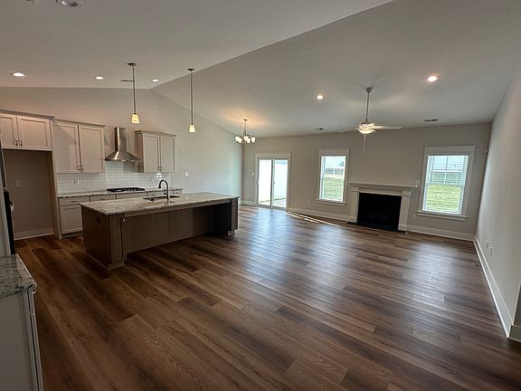 Open floorpan, kitchen, living room and dining area with vaulted ceilings