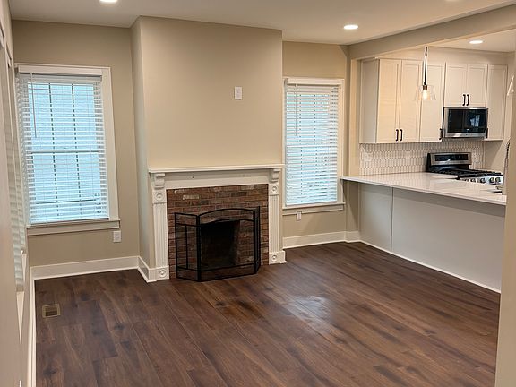Great Room flooded with natural light with new LVP Flooring and new windows with blinds.
