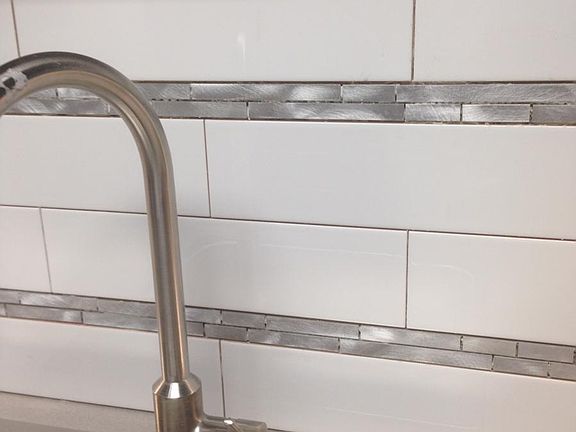 Kitchen tile with stainless steel accents