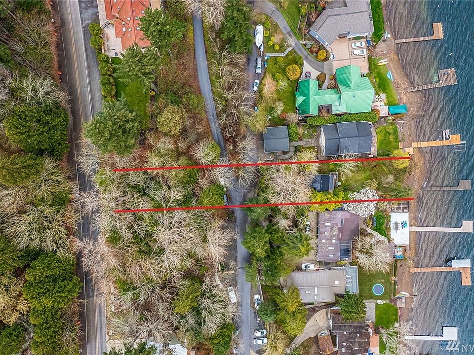 Boasting 50 feet of no bank waterfront, the red lines roughly denote the 16,424 sf property, running from W Lake Sammamish Parkway to the water, offering rare privacy with a wooded sloped backdrop to the building envelope.