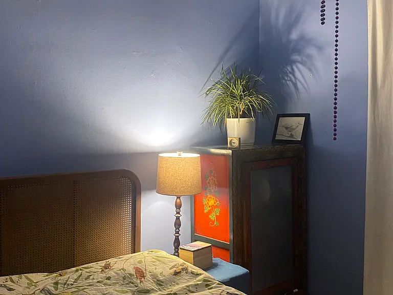 Blue bedroom: this one includes a queen bed, desk, chair, and wardrobe.