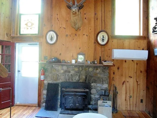 Living room - plenty of light and fully functional woodstove with new mini-split