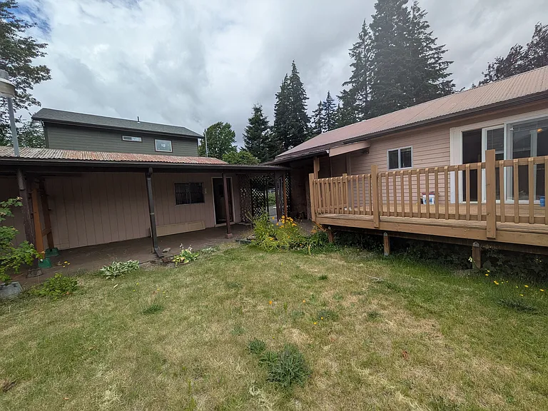 Backyard facing garage to left and house to right.