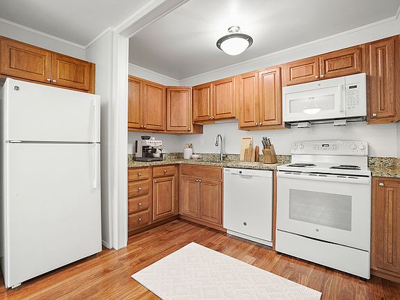 Kitchen - from dining room view with fridge, dishwasher, stove, microwave, sink, essentials, and decor ( VS )1
