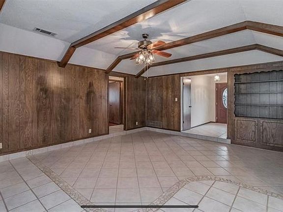 Living room, looking toward front door and to the opening to the three kid bedrooms.