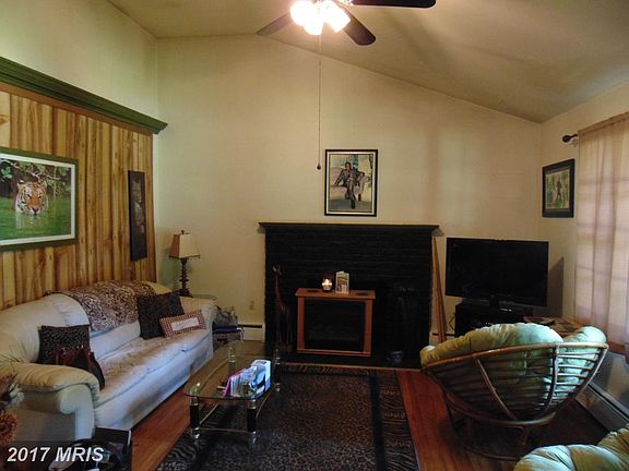 Light filled living room w/ wood burning fireplace