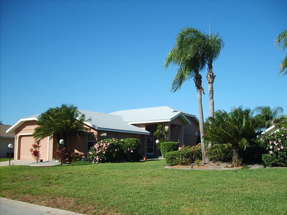 View of house and berm from corner of lot