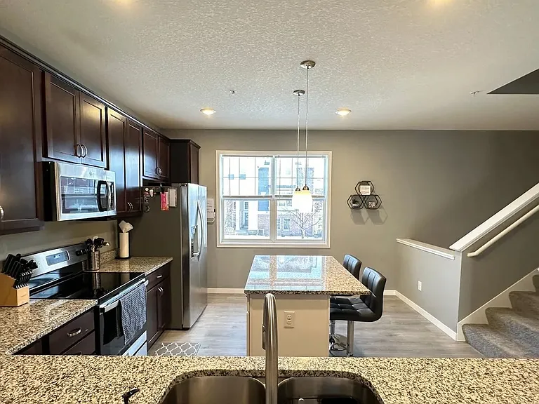 Elevate your lifestyle at LS Capital Group with this stunning kitchen featuring modern finishes, ample natural light, and an inviting dining space. Perfect for culinary adventures and gatherings. Schedule your visit today and see for yourself!