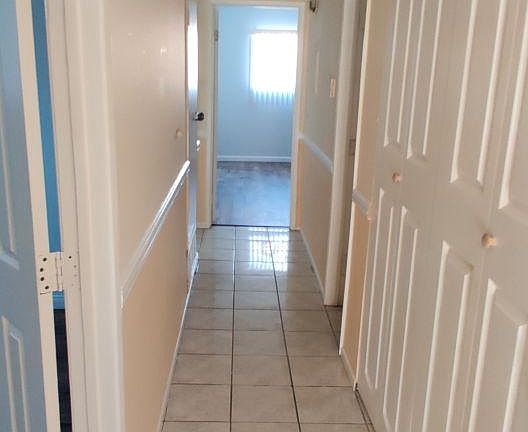Hallways to the bedrooms. First bedroom is on the left. The Washer Dryer space is the first one on the right