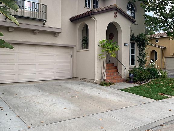 Nice wide driveway and welcoming terra-cotta staircase leading to front door