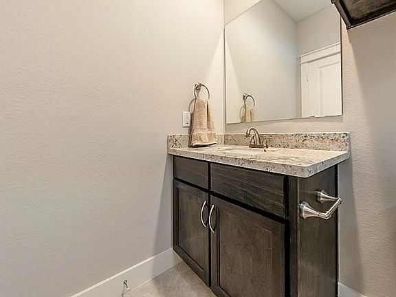 Guest Bath: First Floor Full Bath with Porcelain tile and espresso cabinets and granite vanity!