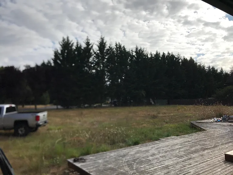 large, flat one acre back "yard" and large deck