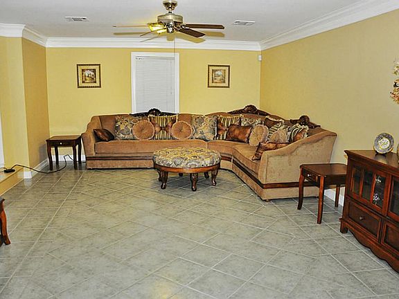 Roomy living room. with window nook and beautiful crown molding. 13'x20'