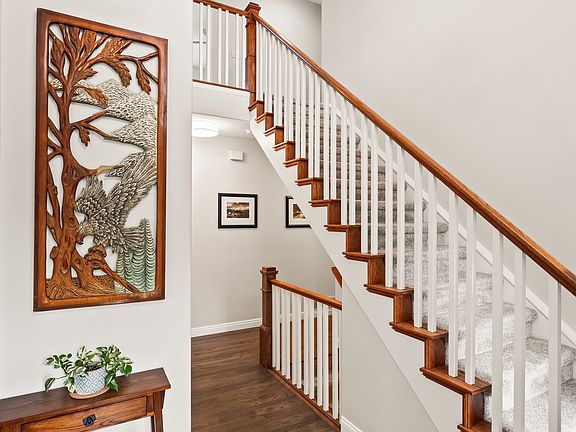 Hall closet, half bath, and staircases to 2nd level and basement
