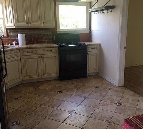 Kitchen - granite countertops, stone flooring, new stainless steel refrigerator, new hood over stove, microwave, fridge and stove included.