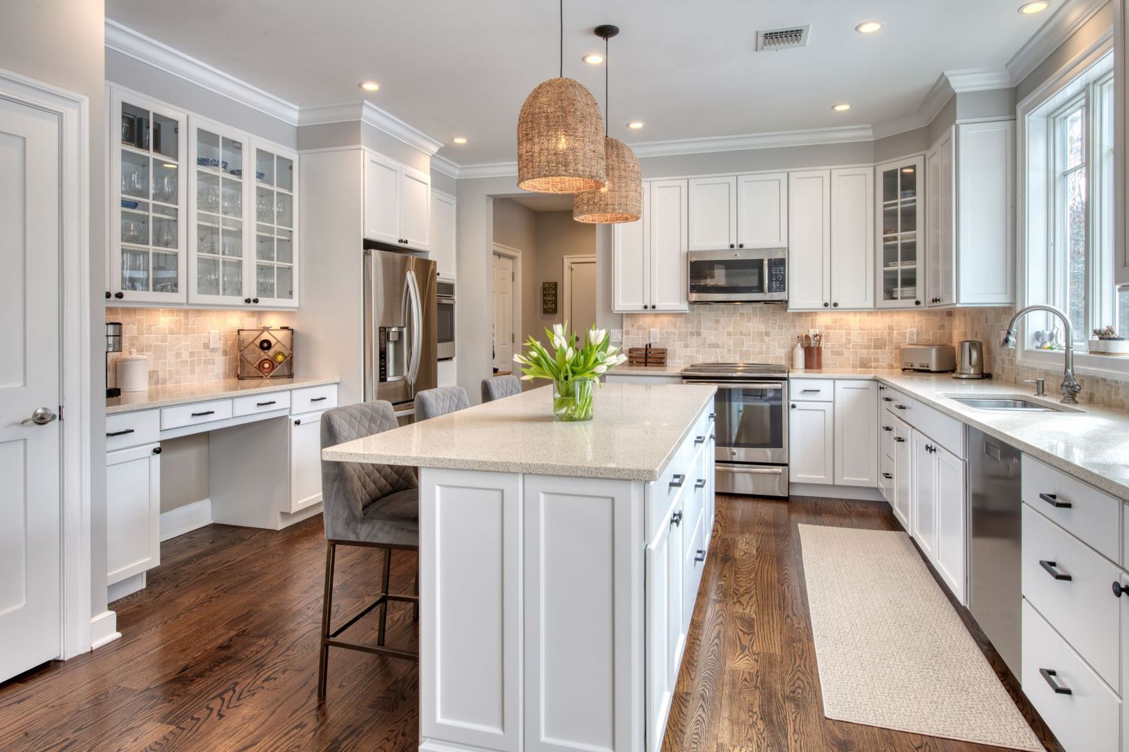  well-equipped kitchen with an island and connecting walkway to garage and side entrance