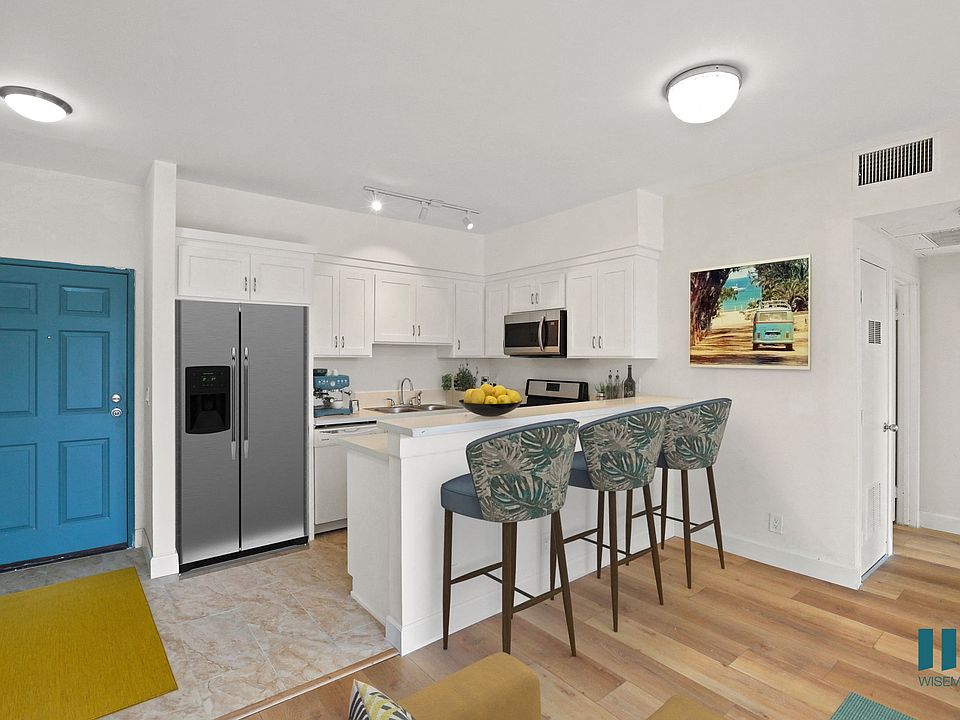 Front Entrance and Open-Concept Kitchen with Countertop Bar