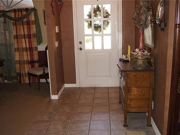 Front entry way and tile floors leading into formal dining area and formal living room
