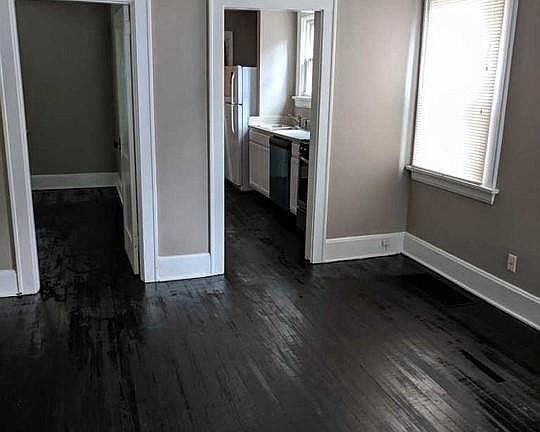 Living room. Freshly painted walls and stained hardwood floor.