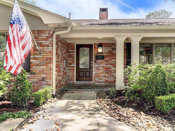 Front Porch: curved sidewalk with brick detail terminates in to front porch with Double fluted columns accented by slated walkway.