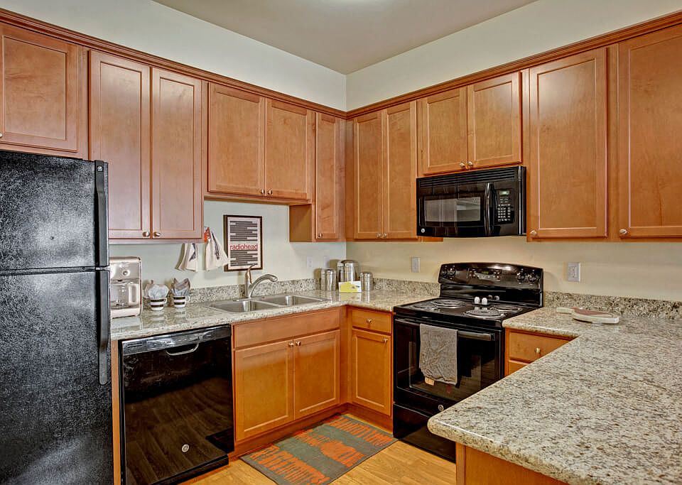 A large kitchen with lots of cabinet sorage, deep double sinks, and plenty of counter space