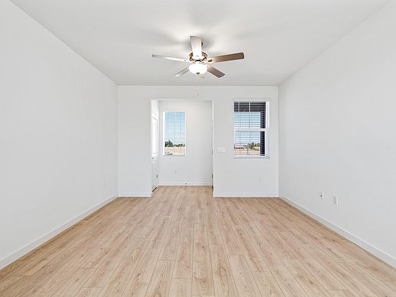 The family room is spacious with a ceiling fan.