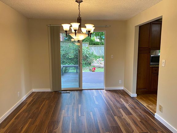 The dining area opens to sundeck with built-in seating and a private, fenced backyard.