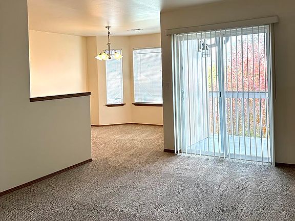 Living Room off of the kitchen. Bay windows giving extra space in the dining room. Nice deck off of the main living area.