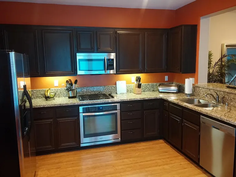 Kitchen with granite counter tops and SS appliances