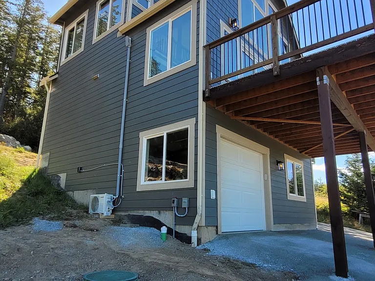 Angled from ground hill up garage with windows