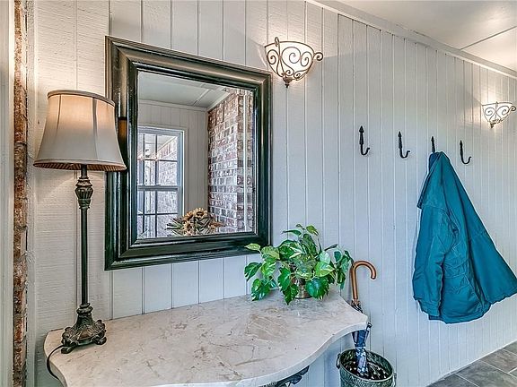 Large enclosed entry porch on front of home.