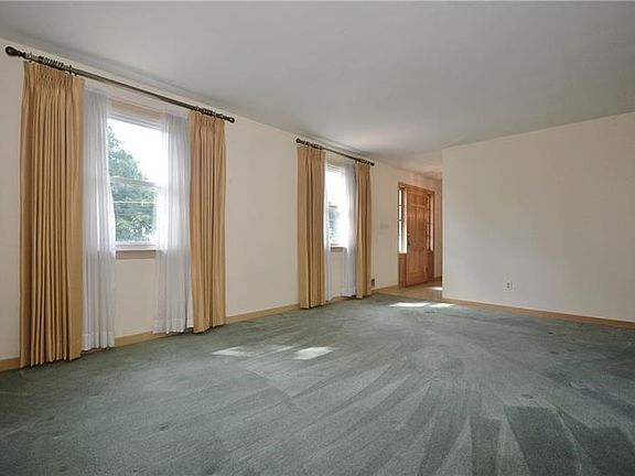 Living room is large and bright, with original hardwood floors, ready to add your custom decorating taste.