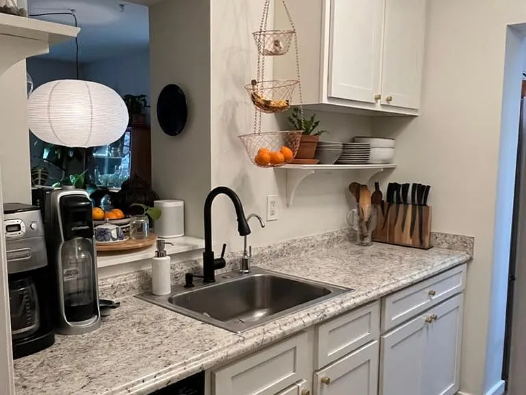 Galley kitchen is functional and equipped with cookware, dining ware, small appliances, gas stove, convection oven, microwave and Mr. Coffee coffee pot with grinder.