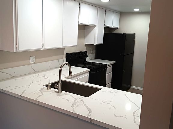 Quartz countertops and new appliances. Freshly painted cabinets brighten kitchen.