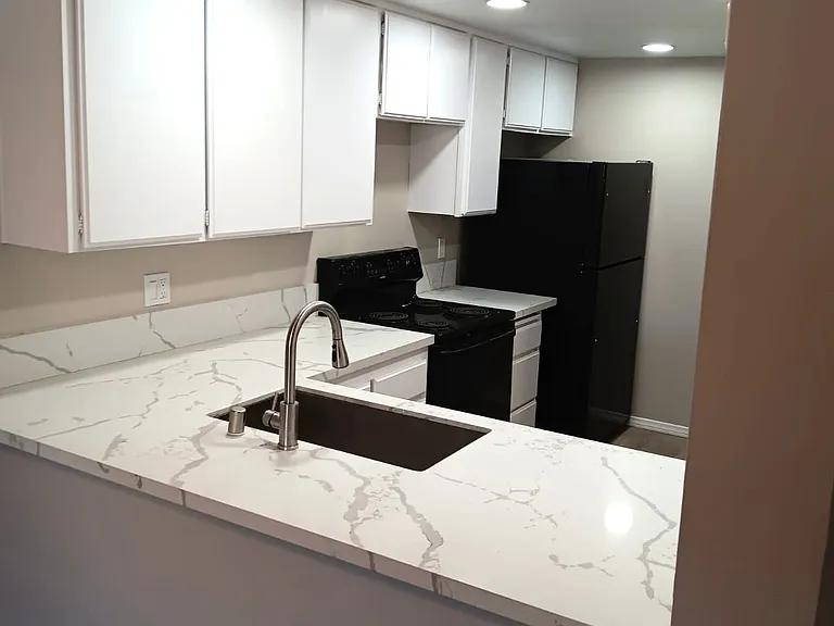 Quartz countertops and new appliances. Freshly painted cabinets brighten kitchen.