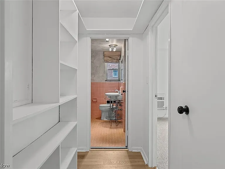 Small hallway w/shelves, linen closet and larger storage closet