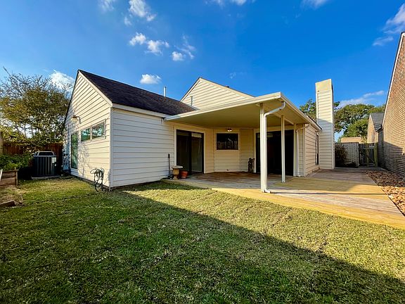 Backyard with huge covered patio and large deck for entertaining.