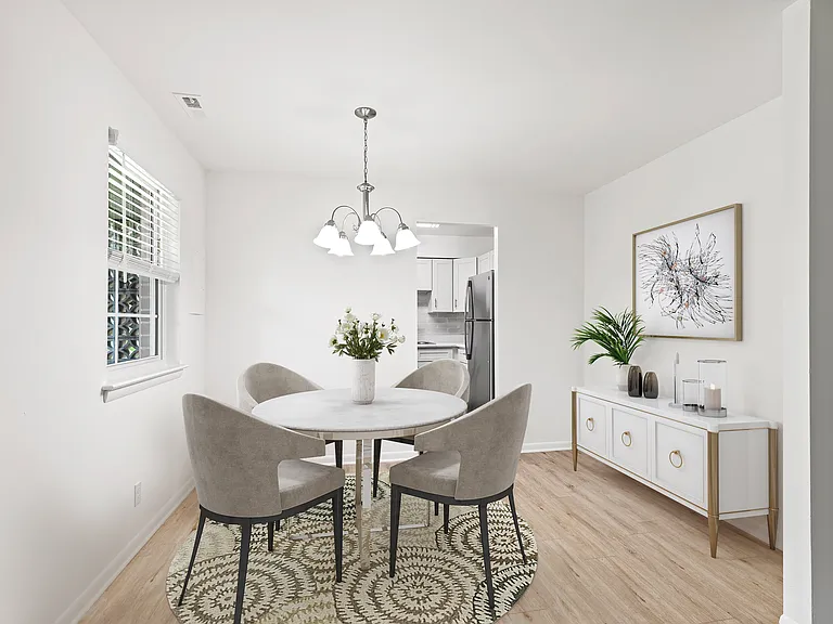 Dining Area with Vinyl Plank Flooring (shown here in a 2-bedroom floor plan with model furniture)