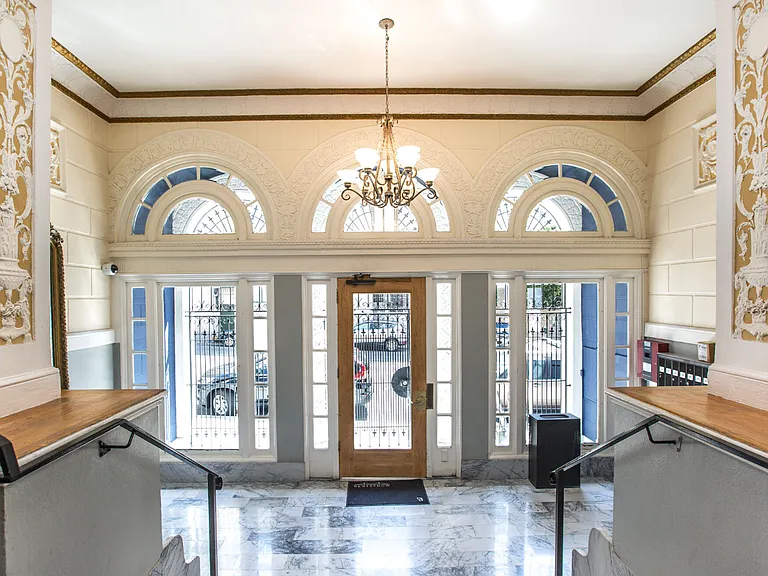 Elegant lobby with a chandelier, and Victorian-style interior design