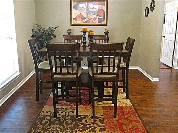 Enjoy dining in this Elegant room with warm colors, crown molding, and decorative ledges above.