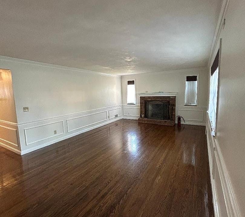 The living room is spacious and has lots of natural window light, hardwood flooring and room for your largest furniture