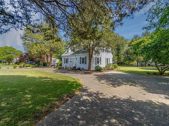 Large, circular, brick paver driveway offers tons of parking space