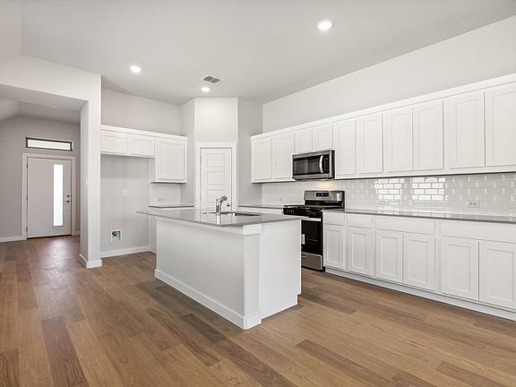 Kitchen in the Cedar home plan by Trophy Signature Homes - REPRESENTATIVE PHOTO