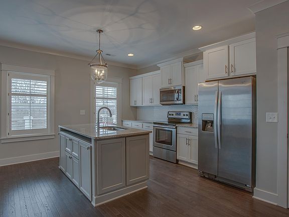Broad view of kitchen, door to right is pantry closet.
