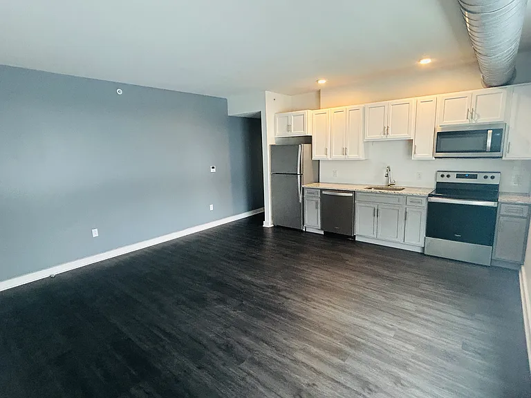 Livng Room / Kitchen open plan features plenty of natural light from large windows.