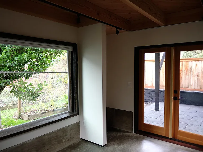 Bedroom looking through French doors towards your private shade patio.