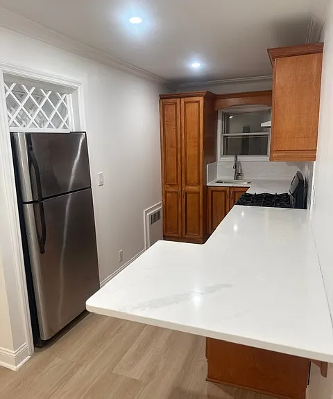 Full kitchen with appliances, backsplash and quartz counters